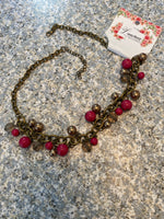 Petra-Cute short necklace, with pink and transparent beads and its chain is brass or dark gold