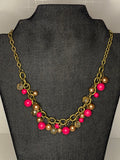 Petra-Cute short necklace, with pink and transparent beads and its chain is brass or dark gold